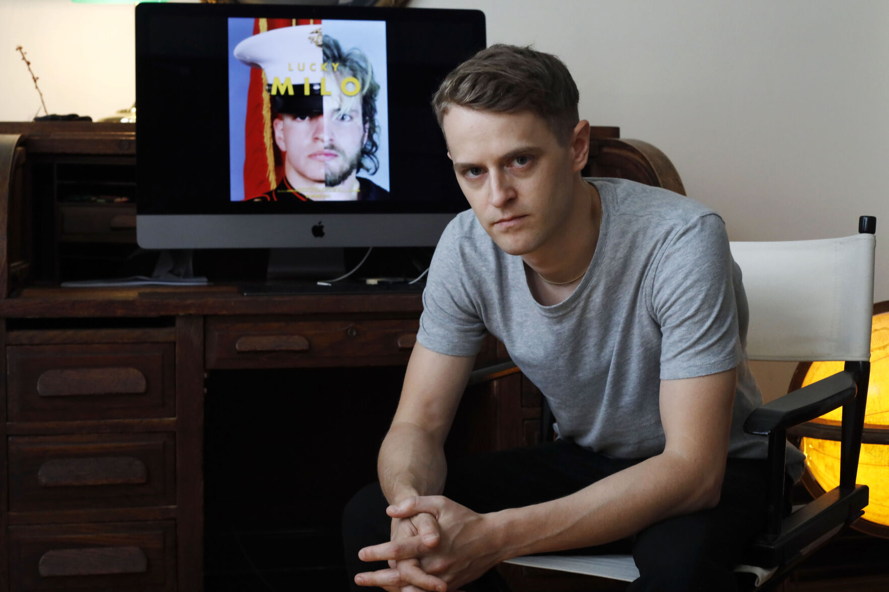filmmaker Edmund Milligan Marcus in front of Lucky Milo film on computer